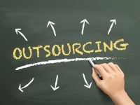 outsourcing word written by hand over chalkboard
